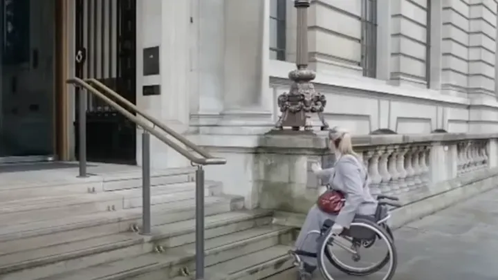 This lady in a wheelchair couldn't climb the stairs, but watch what happens when she pushes the button