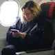 This 'normal' airplane passenger is actually a world famous singer! Do you see who it is?