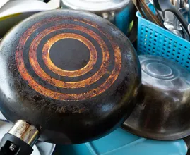 The side of the pan nobody scrubs: why a crusty bottom can scratch your hob, and the kitchen-cupboard remedies that shift it