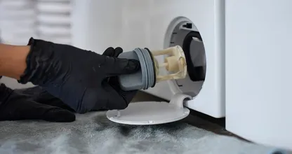 The little hatch at the bottom of your washing machine is the first thing repair technicians open, and most owners have never touched it